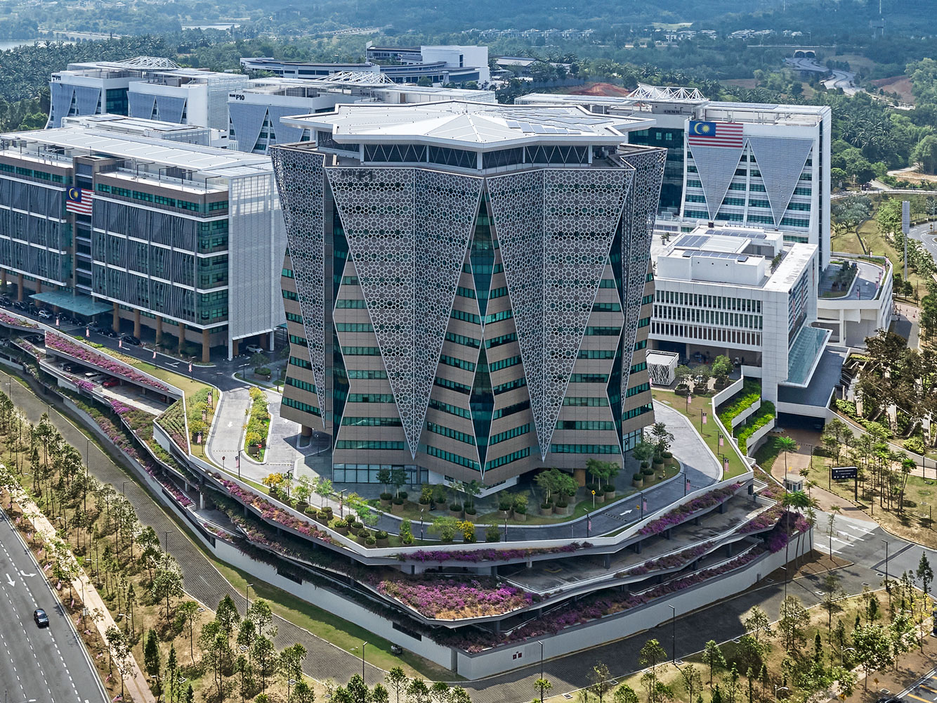 Modern office complex showcasing contemporary architecture, landscaping, and infrastructure, part of a government concession project